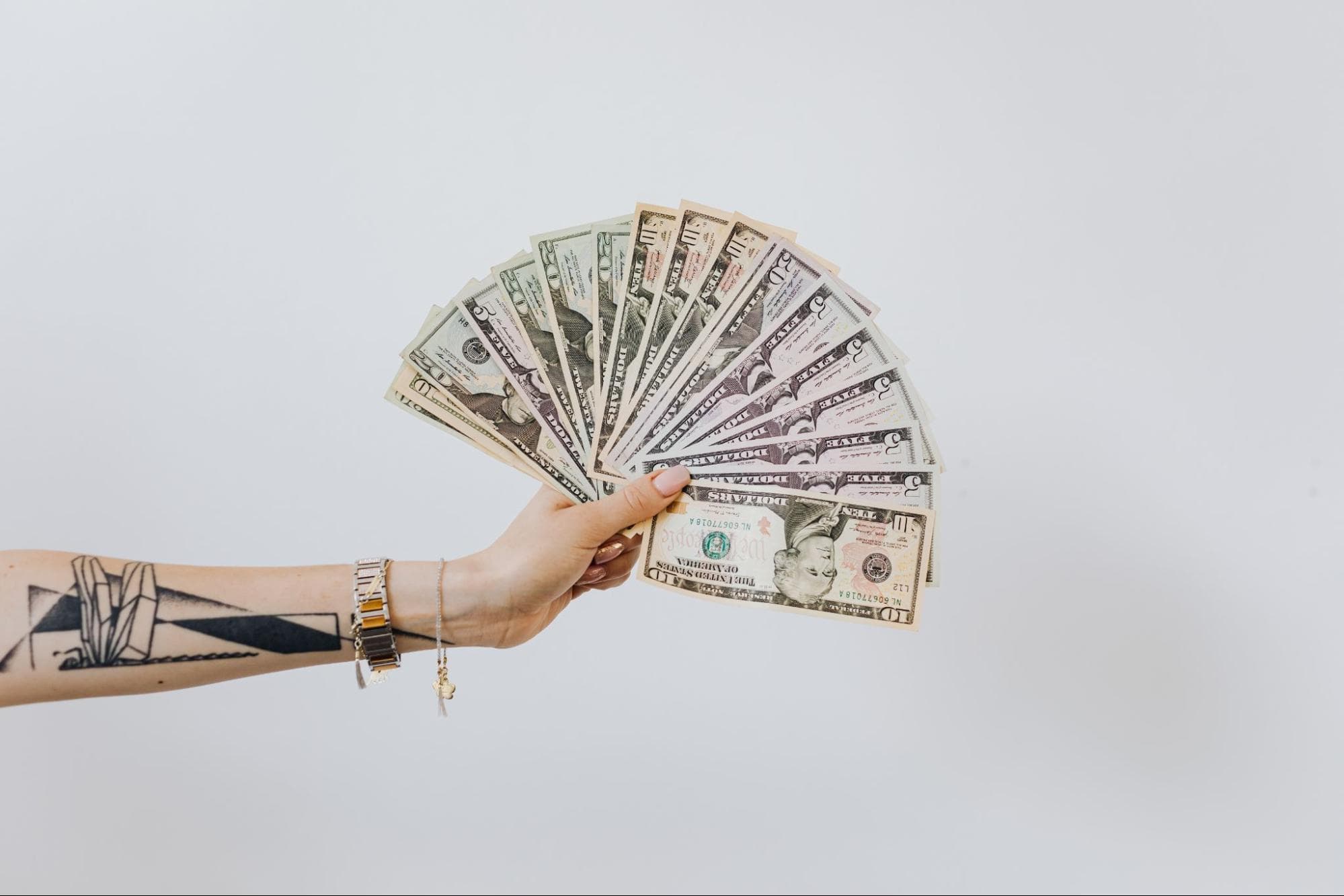 a hand holding bills
