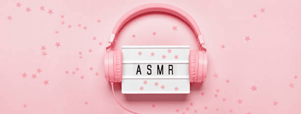 asmr board with pink headphones and pink background