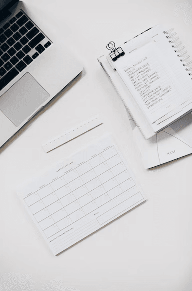 a macbook, paper, notebook