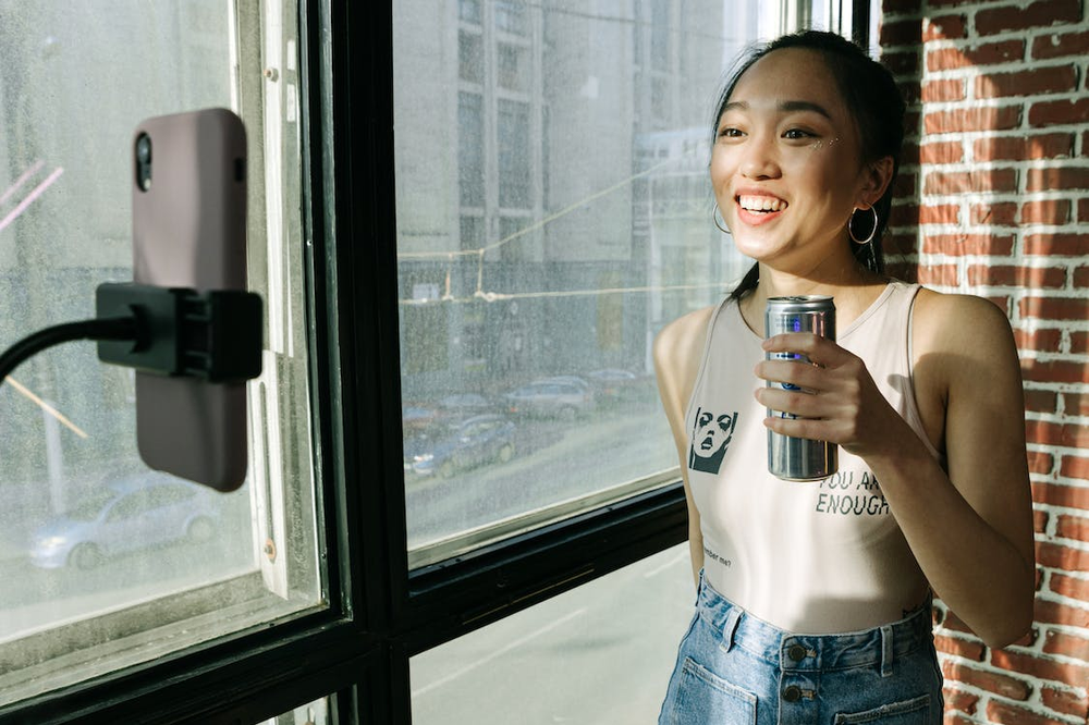 a content creator holding a drink