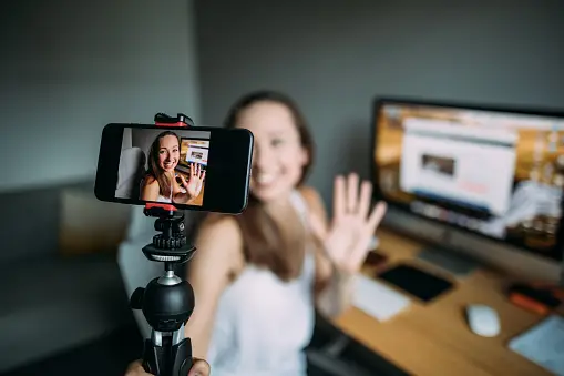 a woman recording a video of herself