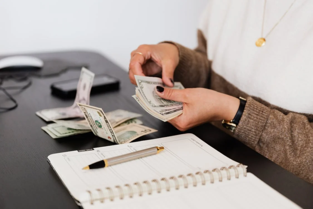 a person holding dollar bills