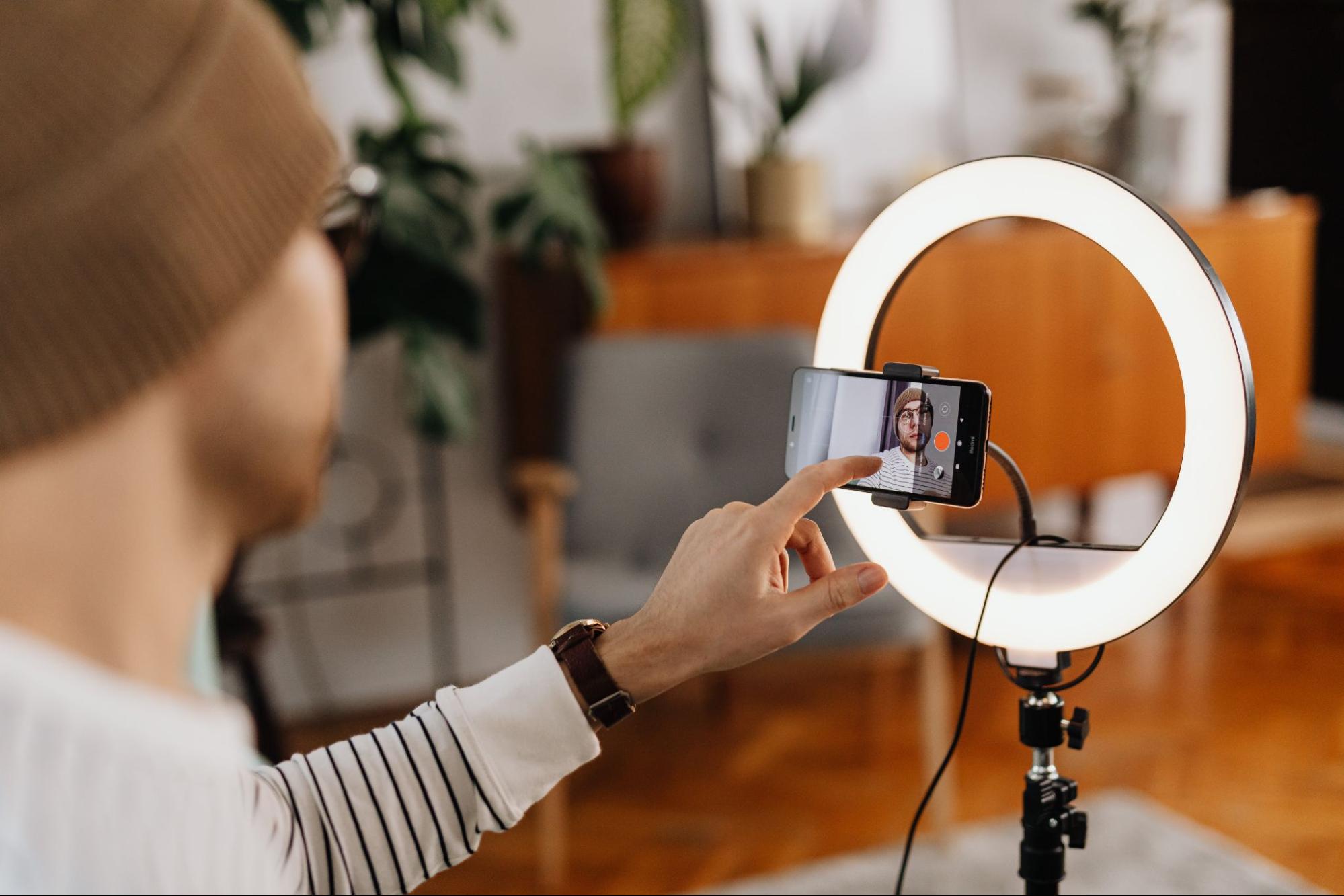 an influencer recording a video with ring light