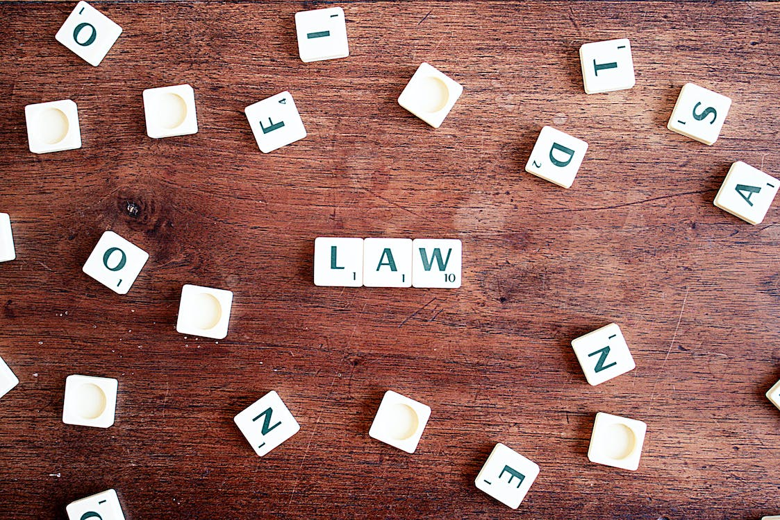 the word law spelled using scrabble pieces